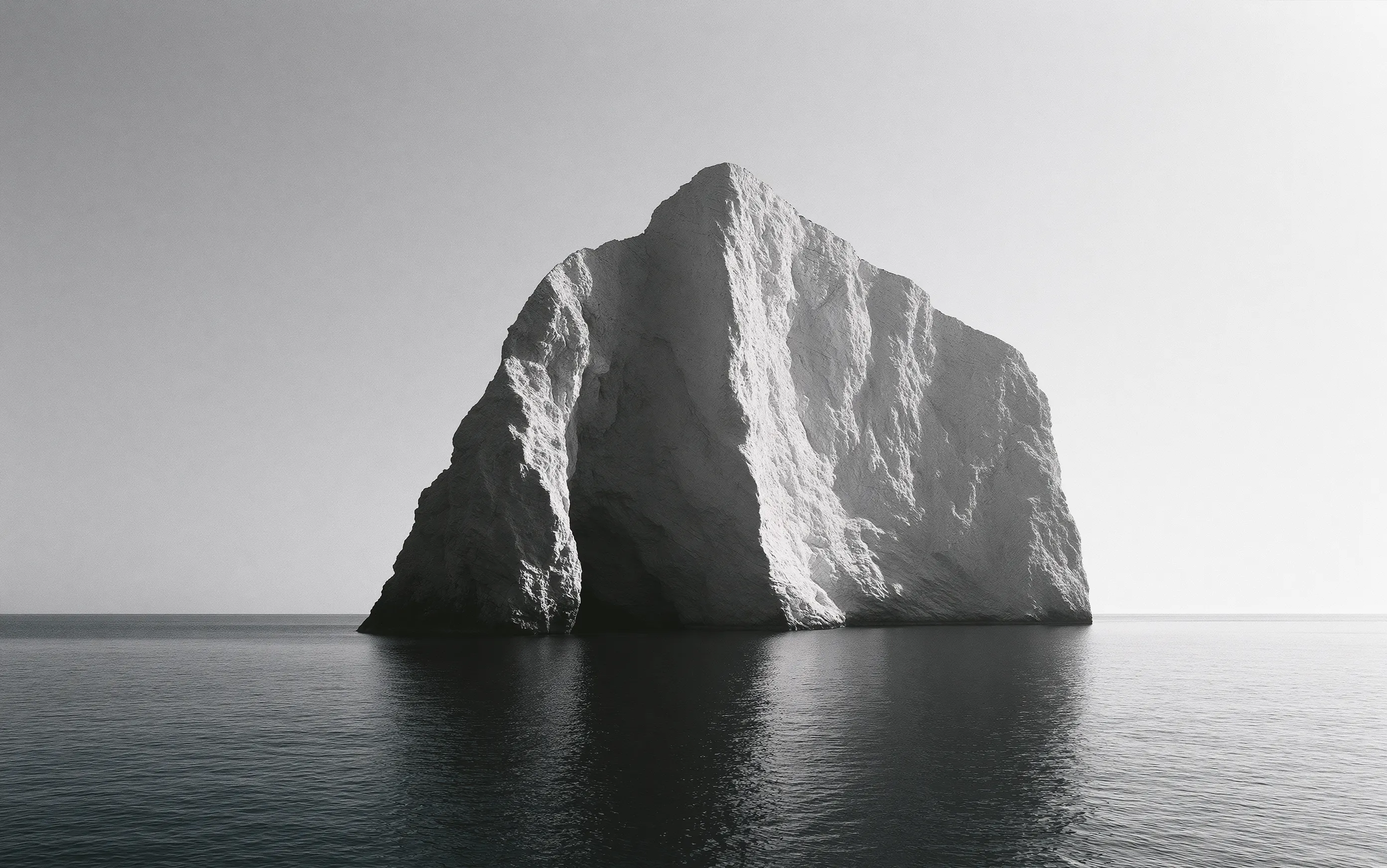 Sunlit white chalk cliffs above a dark sea, high contrast, horizon low in the frame